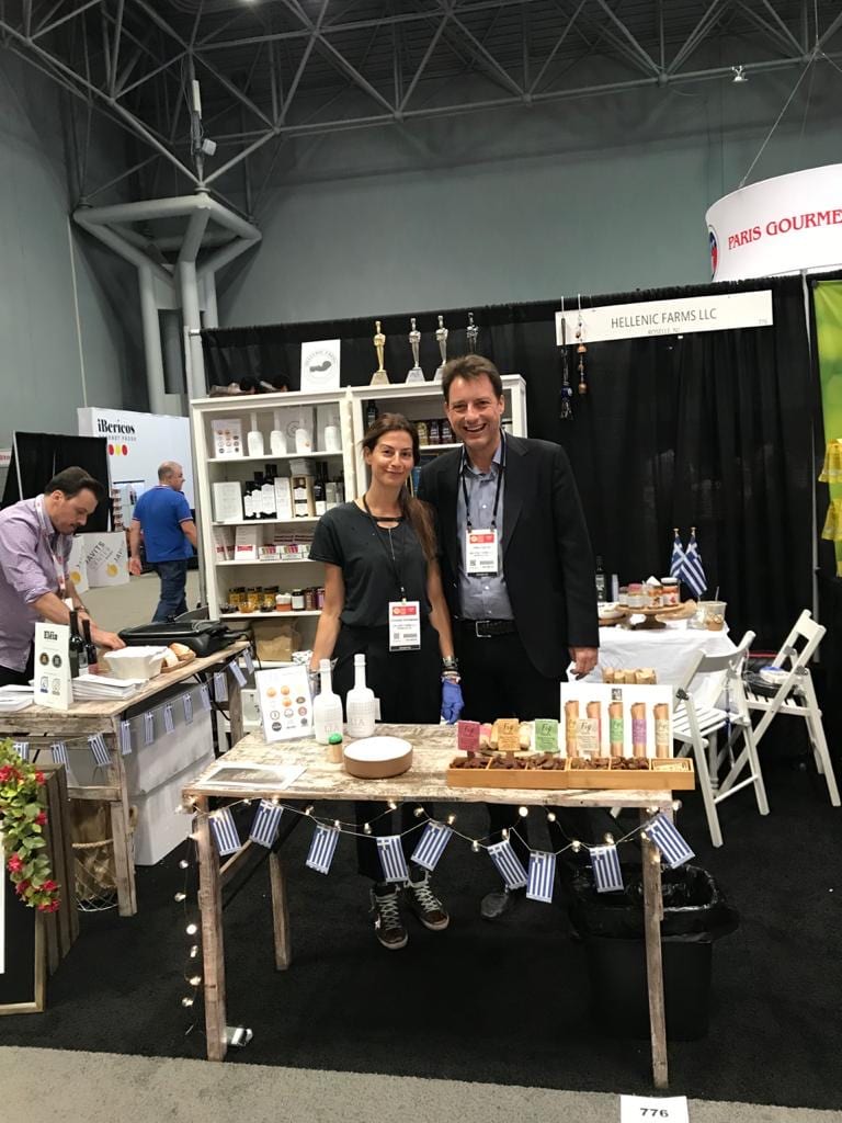 Vivianna Karamanis, founder of Hellenic Farms, with her husband, Theophilos Tziotis, beam with pride at a display of Hellenic Farms Products