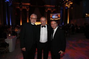 Father Alexander Karloutsos, Honorary Advisor, stands with Andrew N. Liveris and Peter Diamandis at The Hellenic Initiative Gala.